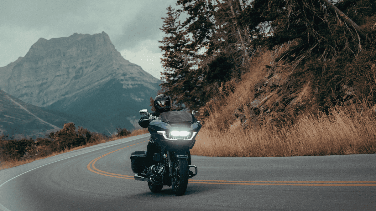Rider on a 2025 Harley-Davidson CVO Road Glide cruising a mountain curve near Mount Pleasant, TN