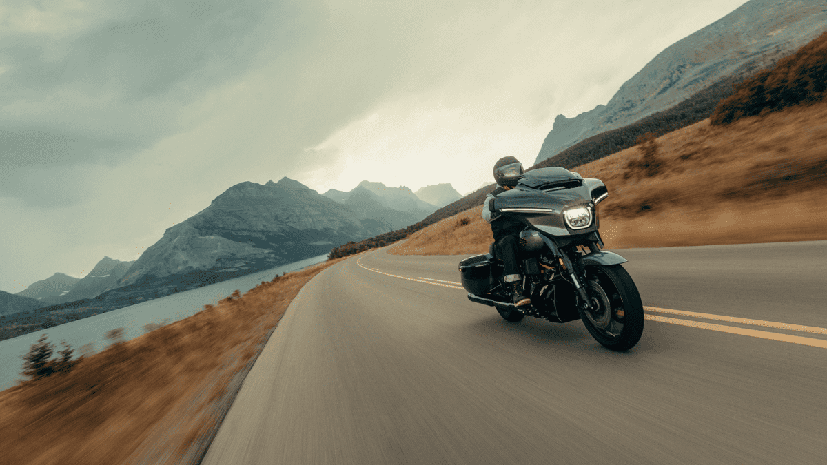 2025 Harley-Davidson® CVO™ Street Glide® in motion along scenic lakeside highway near Mount Pleasant, TN