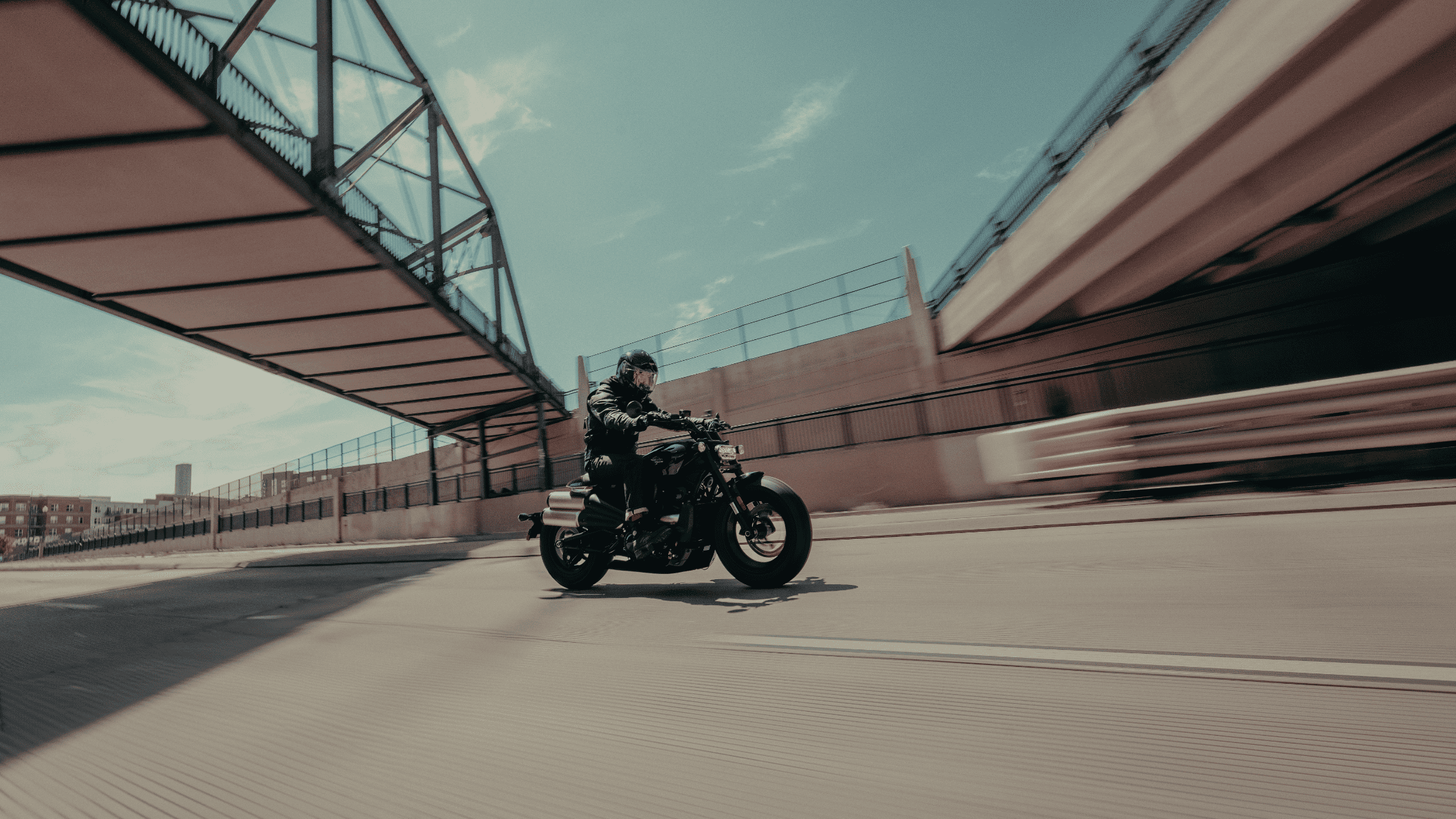 A rider accelerates through an urban landscape on The 2025 Harley-Davidson® Sport Motorcycle in Nash…