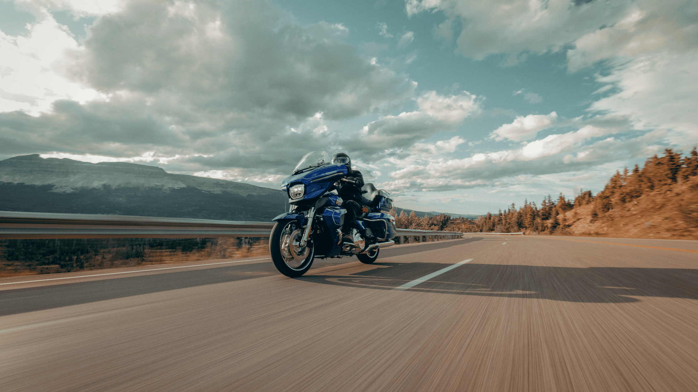 A rider cruises down an open highway on The 2025 Harley-Davidson® Street Glide® Ultra in Nashville,…